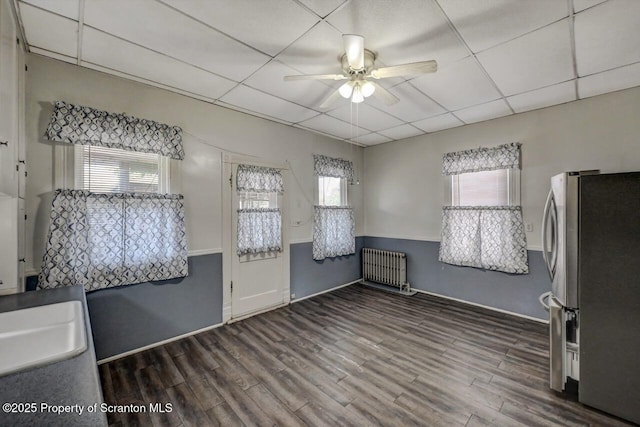 126-128 S Rebecca Ave S, Scranton, PA 18504 - unfurnished dining area featuring radiator heating unit, a ceiling fan, wood finished floors, baseboards, and a drop ceiling