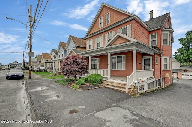 126-128 S Rebecca Ave S, Scranton, PA 18504 - view of front of home with a porch, a chimney, a shingled roof, and a residential view
