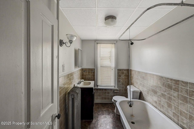 126-128 S Rebecca Ave S, Scranton, PA 18504 - full bath featuring tile walls, a garden tub, radiator heating unit, toilet, and vanity