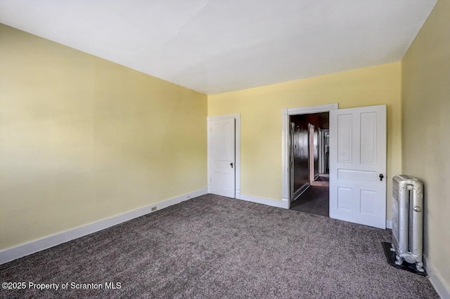 126-128 S Rebecca Ave S, Scranton, PA 18504 - unfurnished bedroom with radiator heating unit, dark carpet, and baseboards