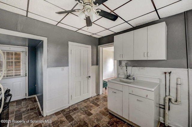 126-128 S Rebecca Ave S, Scranton, PA 18504 - kitchen featuring a sink, ceiling fan, light countertops, dark stone finish floors, and white cabinets