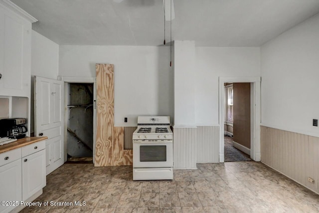126-128 S Rebecca Ave S, Scranton, PA 18504 - kitchen featuring white range with gas cooktop, wainscoting, and white cabinets