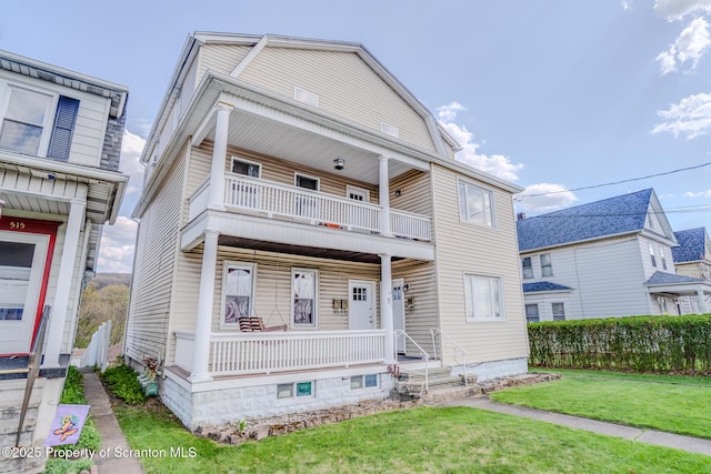 view of front of property with a porch, a front lawn, and a balcony