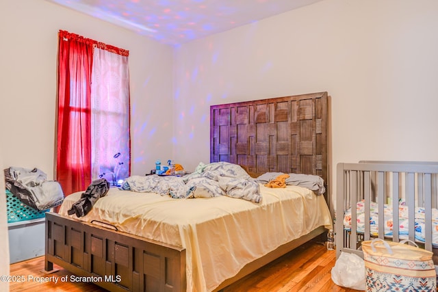 bedroom featuring wood-type flooring