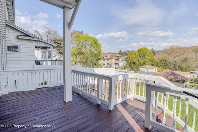 deck featuring fence and a residential view