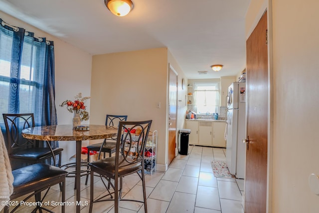 dining area with light tile patterned flooring