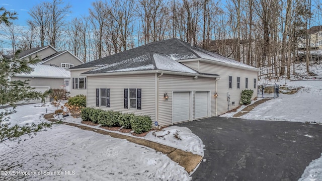 view of snowy exterior featuring a garage