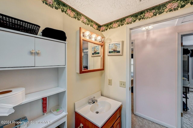 bathroom with vanity and a textured ceiling