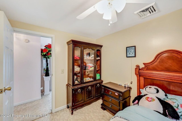 bedroom with light carpet and ceiling fan