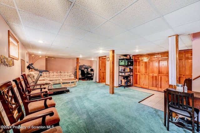 living room with carpet flooring and a paneled ceiling