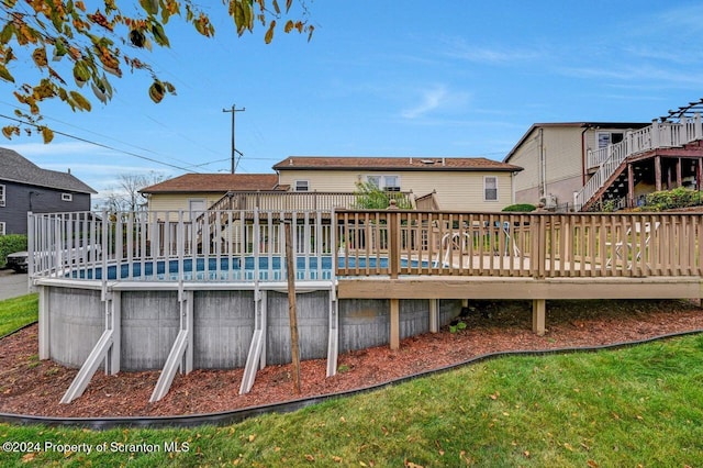 rear view of house featuring a wooden deck