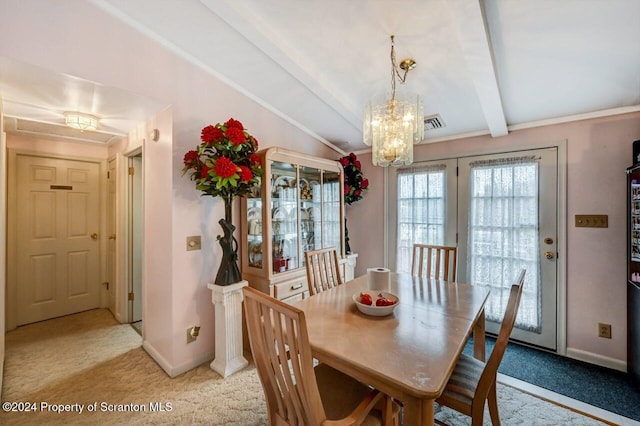 carpeted dining room with crown molding, french doors, lofted ceiling with beams, and an inviting chandelier