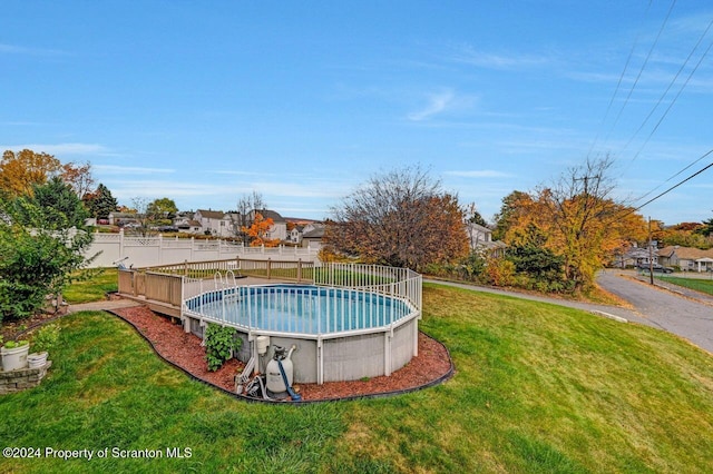 view of swimming pool with a yard