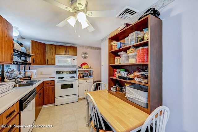 kitchen with white appliances, ceiling fan, and sink