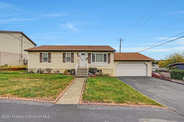 view of front of home with a front lawn and a garage