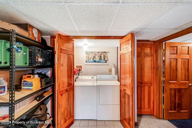 laundry area with light tile patterned floors and independent washer and dryer