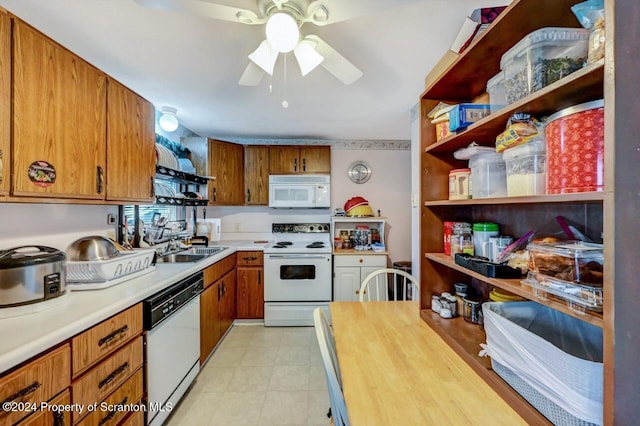 kitchen featuring white appliances, butcher block countertops, ceiling fan, and sink