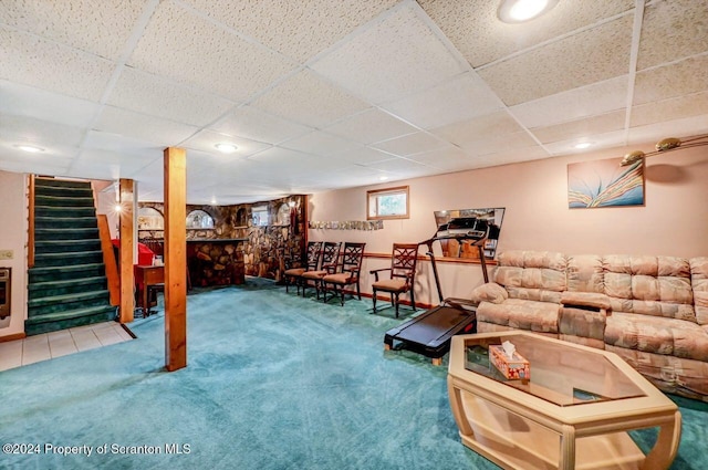 living room featuring carpet and a paneled ceiling