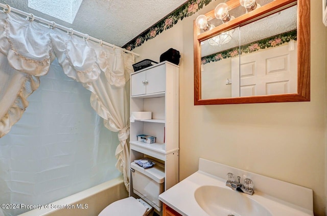 full bathroom with shower / bath combo, toilet, a textured ceiling, and vanity