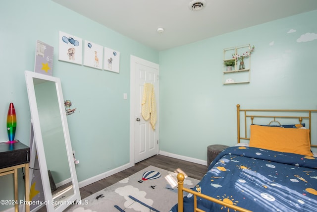 bedroom with dark hardwood / wood-style floors