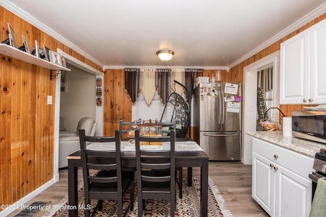 dining room featuring ornamental molding and hardwood / wood-style flooring