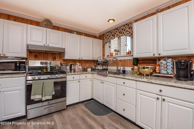 kitchen with white cabinets, crown molding, sink, and stainless steel appliances