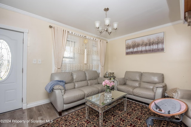 living room with hardwood / wood-style floors, a notable chandelier, and ornamental molding