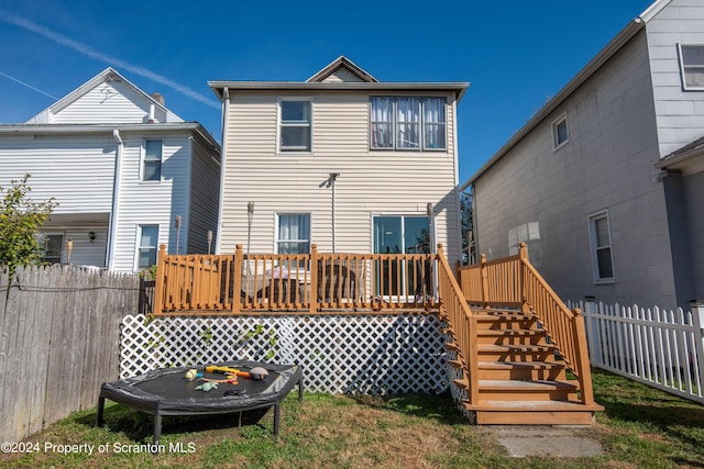 back of house featuring a wooden deck