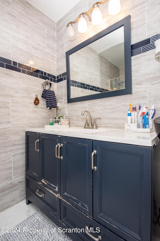 bathroom with vanity and tile walls