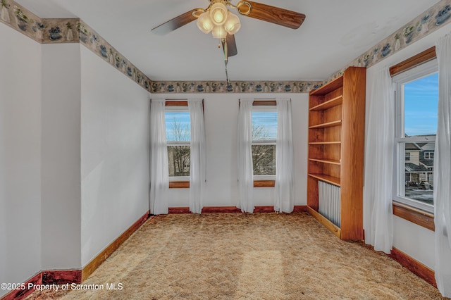 carpeted empty room with ceiling fan