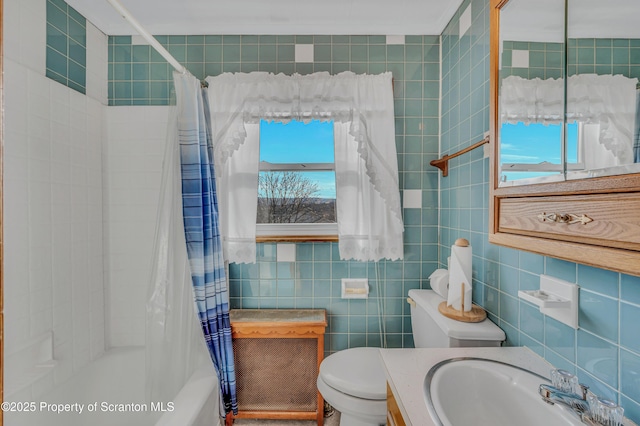 full bathroom featuring vanity, tile walls, shower / tub combo with curtain, and toilet