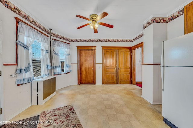 kitchen featuring crown molding, ceiling fan, and white fridge