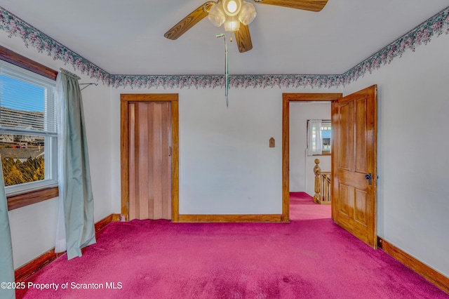 carpeted spare room featuring ceiling fan