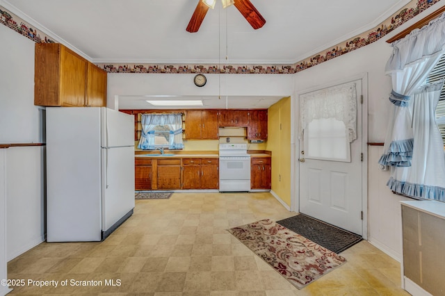 kitchen with ceiling fan, sink, and white appliances