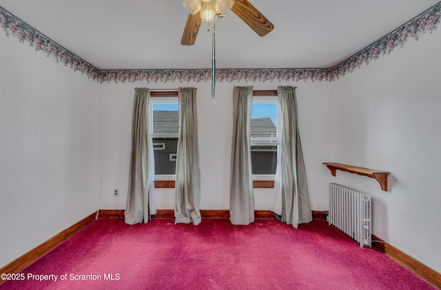 spare room with radiator, ceiling fan, and carpet flooring