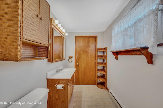 bathroom with vanity, tile patterned floors, a baseboard radiator, and toilet