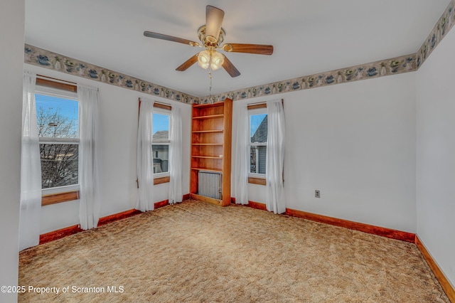 spare room featuring ceiling fan and carpet flooring