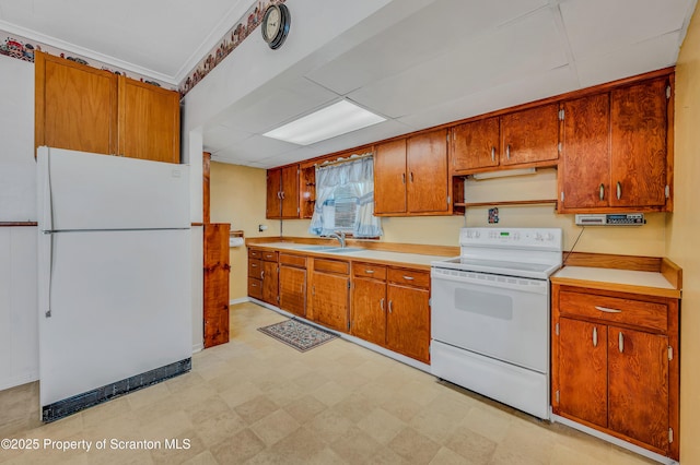 kitchen with white appliances, sink, and a drop ceiling