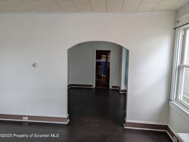 430 14th Ave, Scranton, PA 18504 - spare room with arched walkways, ornamental molding, baseboards, and dark wood-style flooring
