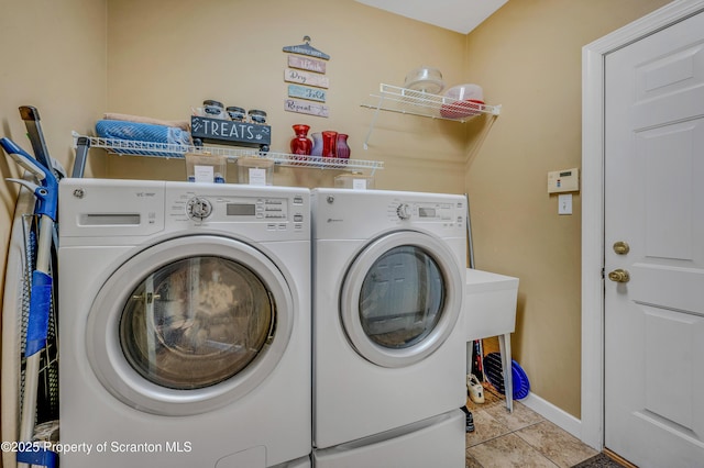 laundry room with separate washer and dryer and light tile patterned floors