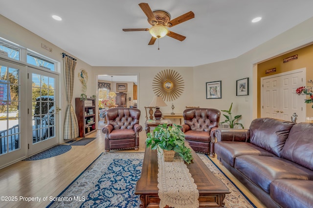 living room featuring ceiling fan and wood-type flooring