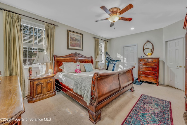 bedroom with ceiling fan and light carpet