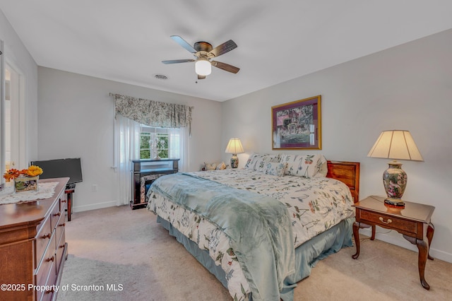 bedroom featuring ceiling fan and light colored carpet