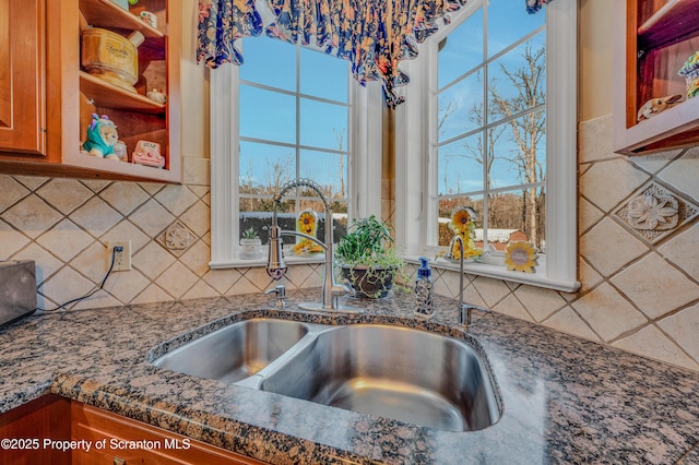 room details featuring dark stone countertops and sink