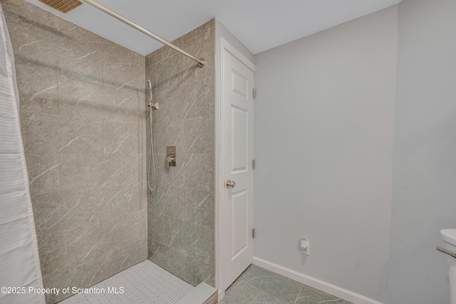 8 Eight Iron Dr, Mountaintop, PA 18707 - bathroom with tiled shower, baseboards, toilet, and tile patterned floors
