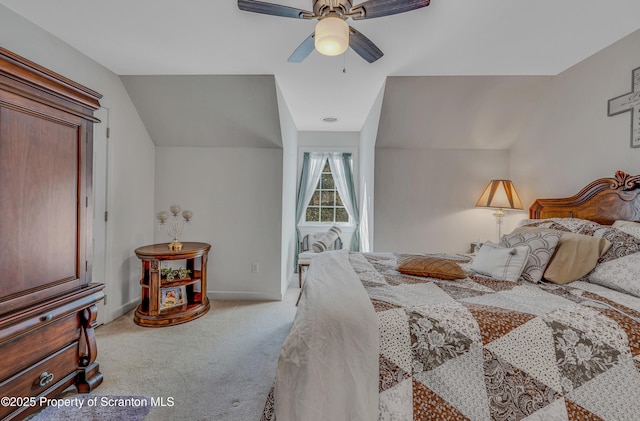 carpeted bedroom with ceiling fan and lofted ceiling