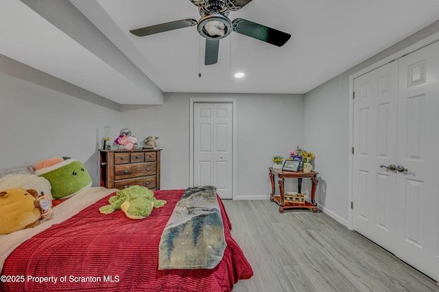 bedroom with ceiling fan and light hardwood / wood-style floors