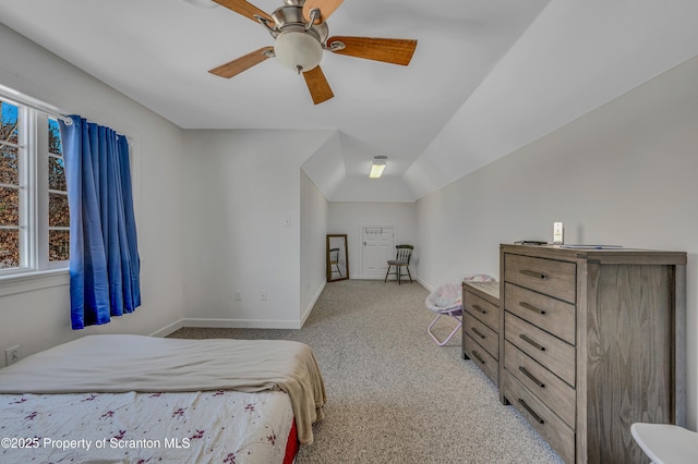 carpeted bedroom featuring lofted ceiling and ceiling fan