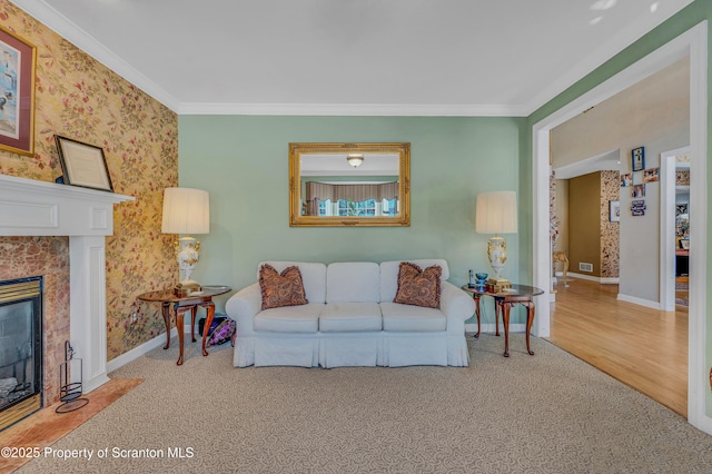 carpeted living room featuring ornamental molding and a fireplace