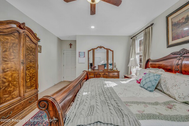 bedroom with ceiling fan and light colored carpet